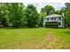 Well-maintained backyard features a lush lawn, volleyball net, and surrounding trees at 1976 Liberia Rd, Wadmalaw Island, SC 29487