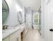Bright bathroom with marble counters, dual sinks, soaking tub and a glass enclosed shower at 1976 Liberia Rd, Wadmalaw Island, SC 29487