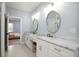 Bathroom boasts dual sinks with marble countertops, vanity, and Herringbone tile floors at 1976 Liberia Rd, Wadmalaw Island, SC 29487