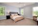 Spacious bedroom featuring a large bed, carpeted floors, natural light, and serene atmosphere at 1976 Liberia Rd, Wadmalaw Island, SC 29487