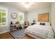 Comfortable bedroom with natural light, a desk and a cozy rug at 1976 Liberia Rd, Wadmalaw Island, SC 29487