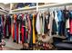 Walk-in closet with rows of hanging clothes and shoes at 1976 Liberia Rd, Wadmalaw Island, SC 29487