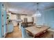 Open-concept dining area with hardwood floors, a chandelier, and easy access to the kitchen at 1976 Liberia Rd, Wadmalaw Island, SC 29487