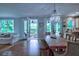 Dining area with hardwood floors flowing into the kitchen and access to the outdoor living space at 1976 Liberia Rd, Wadmalaw Island, SC 29487