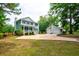 Two-story home with a detached garage and a basketball hoop on a well-maintained lot at 1976 Liberia Rd, Wadmalaw Island, SC 29487