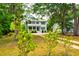 Beautiful two-story home with blue shutters and a well-manicured front yard at 1976 Liberia Rd, Wadmalaw Island, SC 29487