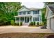 Lovely two-story home with a well-manicured lawn and a garage with a basketball hoop at 1976 Liberia Rd, Wadmalaw Island, SC 29487