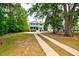 Two-story home with a long driveway lined with mature trees, offering ample parking at 1976 Liberia Rd, Wadmalaw Island, SC 29487