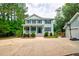 Charming two-story home with a welcoming front porch, garage, and spacious driveway at 1976 Liberia Rd, Wadmalaw Island, SC 29487