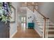 Bright foyer with hardwood floors, staircase, and stylish decor at 1976 Liberia Rd, Wadmalaw Island, SC 29487