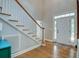 Foyer with hardwood floors, staircase with white railings, and natural light at 1976 Liberia Rd, Wadmalaw Island, SC 29487