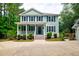 Charming two-story home with light-blue siding, white trim, and a welcoming front porch at 1976 Liberia Rd, Wadmalaw Island, SC 29487