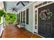 Inviting front porch with comfortable seating and a ceiling fan at 1976 Liberia Rd, Wadmalaw Island, SC 29487