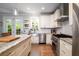 Well-equipped kitchen with granite countertops, stainless steel appliances, tile backsplash, and a center island at 1976 Liberia Rd, Wadmalaw Island, SC 29487
