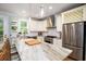 Kitchen with granite countertops, stainless steel appliances, a center island, and white cabinets at 1976 Liberia Rd, Wadmalaw Island, SC 29487