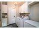 Functional laundry room with a washer, dryer, cabinets, and ample storage space at 1976 Liberia Rd, Wadmalaw Island, SC 29487