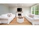 Bright living room featuring a fireplace, hardwood floors and white sofas at 1976 Liberia Rd, Wadmalaw Island, SC 29487