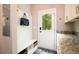 Functional mudroom with a bench, storage, and access to the outdoors at 1976 Liberia Rd, Wadmalaw Island, SC 29487