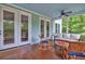 Screened-in porch featuring rocking chairs and an outdoor couch at 1976 Liberia Rd, Wadmalaw Island, SC 29487