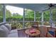 Screened-in porch with seating and view of the backyard at 1976 Liberia Rd, Wadmalaw Island, SC 29487