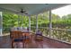 Inviting screened porch with ceiling fan, rocking chairs, and comfortable seating area at 1976 Liberia Rd, Wadmalaw Island, SC 29487