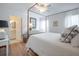 Bedroom with four-poster bed and hardwood floors adjacent to a bathroom at 2011 N Highway 17 # 2300F, Mount Pleasant, SC 29466