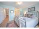 Bright bedroom with light blue walls, decorative mirror, and a comfortable wrought iron bed at 2011 N Highway 17 # 2300F, Mount Pleasant, SC 29466