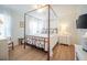 Light-filled bedroom featuring a four-poster bed and light-colored wood-look flooring at 2011 N Highway 17 # 2300F, Mount Pleasant, SC 29466