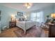 Relaxing bedroom with cool blue walls, a black metal bed frame, and wood-look flooring at 2011 N Highway 17 # 2300F, Mount Pleasant, SC 29466
