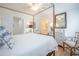 Bright bedroom with hardwood floors, four-poster bed, and adjacent bathroom at 2011 N Highway 17 # 2300F, Mount Pleasant, SC 29466