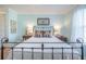 Bedroom featuring a comfortable wrought iron bed, side tables, and soft lighting at 2011 N Highway 17 # 2300F, Mount Pleasant, SC 29466