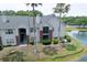 Beautiful condominium building with a tranquil pond view and mature palm trees at 2011 N Highway 17 # 2300F, Mount Pleasant, SC 29466