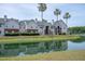 Condominium building surrounded by lush landscaping and a pond with mature palm trees at 2011 N Highway 17 # 2300F, Mount Pleasant, SC 29466