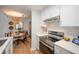 Bright kitchen with white cabinets, stainless appliances, and an adjacent dining area at 2011 N Highway 17 # 2300F, Mount Pleasant, SC 29466