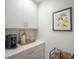 Bright, modern kitchen with white cabinets, quartz countertops, and stylish coffee bar at 2011 N Highway 17 # 2300F, Mount Pleasant, SC 29466