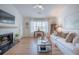 Cozy living room with a fireplace, white sofa, and large windows at 2011 N Highway 17 # 2300F, Mount Pleasant, SC 29466