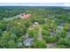 An aerial image displays homes with pools surrounded by trees near a highway and a red-roofed building at 2076 Rookery Ln, Charleston, SC 29414