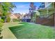 Spacious backyard featuring lush green grass, a private deck with stairs, and a partial view of neighboring homes at 2076 Rookery Ln, Charleston, SC 29414