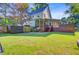 Spacious backyard with a well-maintained lawn, a deck, patio area, and privacy fence for outdoor enjoyment at 2076 Rookery Ln, Charleston, SC 29414