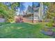 Serene backyard with green lawn, deck, privacy fence, and lush trees offering a peaceful outdoor retreat at 2076 Rookery Ln, Charleston, SC 29414
