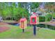 Charming community library boxes near a scenic pond with a fountain, surrounded by lush greenery at 2076 Rookery Ln, Charleston, SC 29414