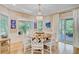 Dining area with large windows, chandelier, and easy access to the outdoor deck at 2076 Rookery Ln, Charleston, SC 29414