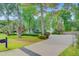 Beautiful two-story home with a long driveway, lush lawn, mature trees, and lovely landscaping at 2076 Rookery Ln, Charleston, SC 29414