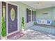Charming front porch with a swing, decorative front door, and well-maintained landscaping at 2076 Rookery Ln, Charleston, SC 29414