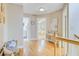 Bright hallway features hardwood floors, neutral walls, and views into the bedroom and bathroom at 2076 Rookery Ln, Charleston, SC 29414