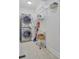 Functional laundry area with stacked washer/dryer and shelving units for storage at 2076 Rookery Ln, Charleston, SC 29414