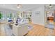 Sunlit living room with hardwood floors and seamless flow to the dining area at 2076 Rookery Ln, Charleston, SC 29414