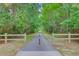 Paved trail cutting through dense trees, offering a scenic and secluded walking experience at 2076 Rookery Ln, Charleston, SC 29414