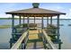 Waterfront gazebo featuring a cozy bench, providing a serene spot to enjoy the surrounding water at 2076 Rookery Ln, Charleston, SC 29414