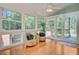 Cozy sunroom with wicker chairs, natural light, and access to the outdoors at 2076 Rookery Ln, Charleston, SC 29414